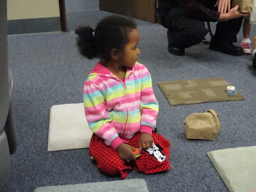 A little girl playing with the sound makers